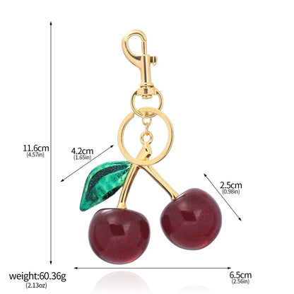 Llavero de cereza roja con charm para bolso y mosquetón dorado en forma de hoja