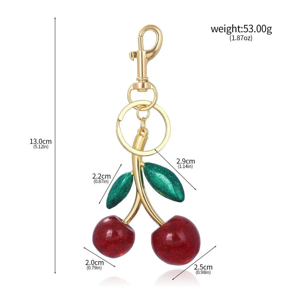 Llavero de cereza roja con charm para bolso y mosquetón dorado en forma de hoja
