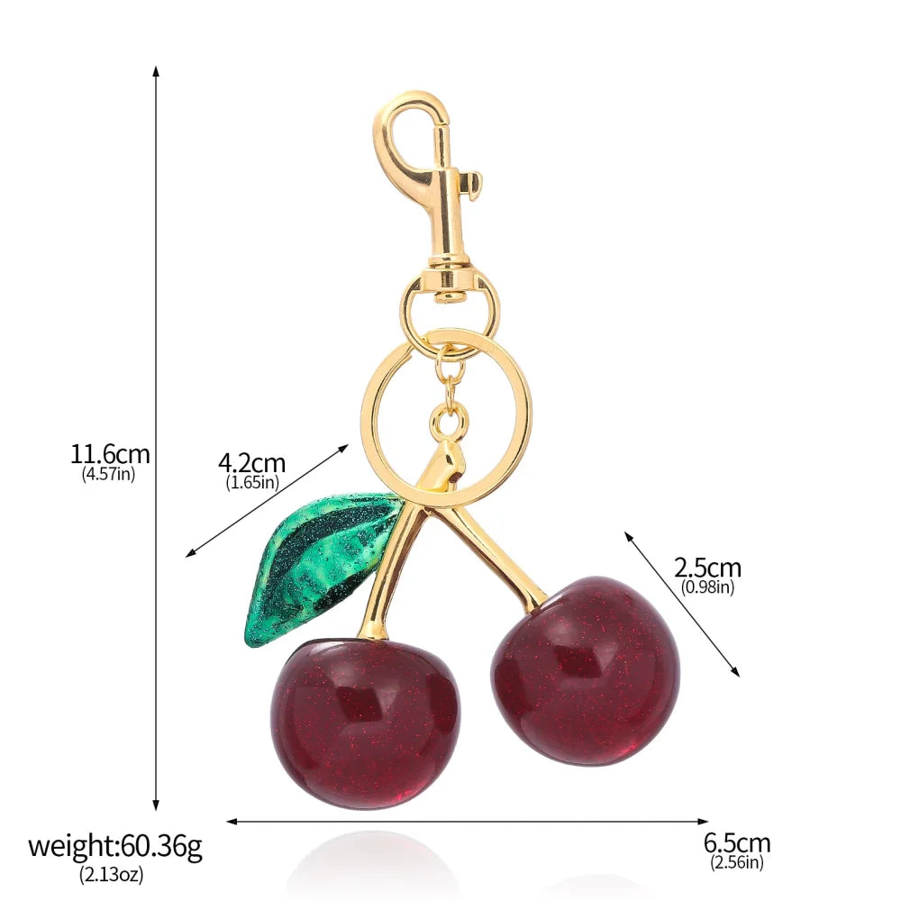 Llavero de cereza roja con charm para bolso y mosquetón dorado en forma de hoja