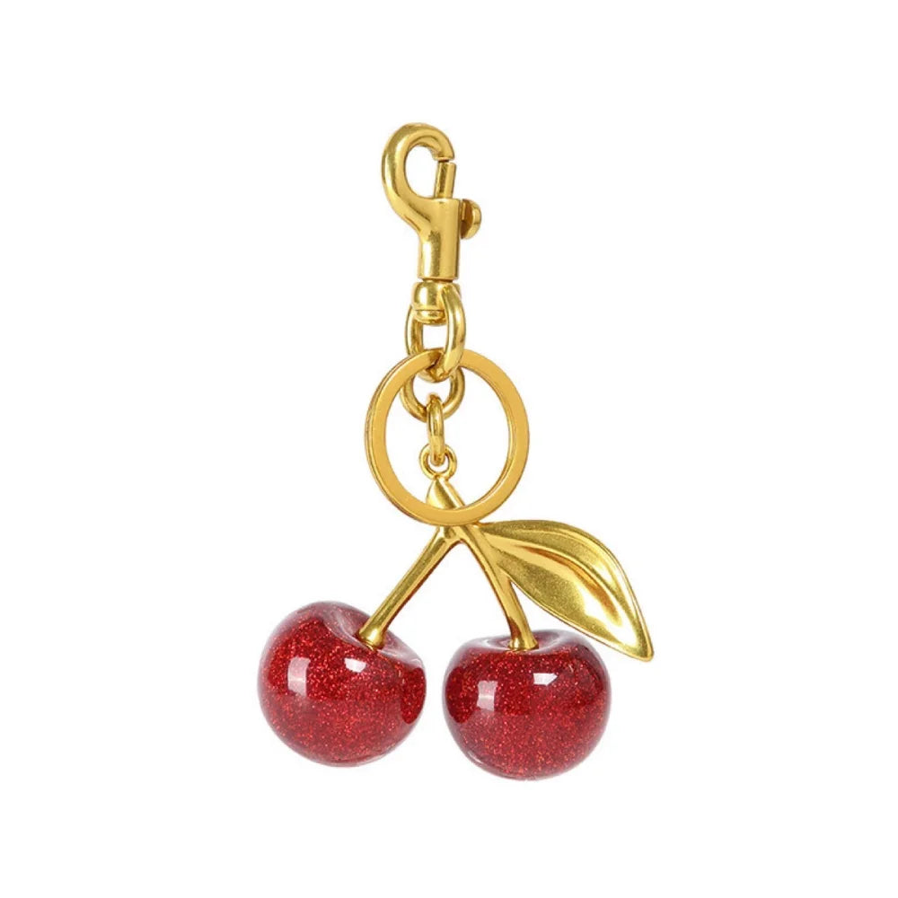 Llavero de cereza roja con charm para bolso y mosquetón dorado en forma de hoja
