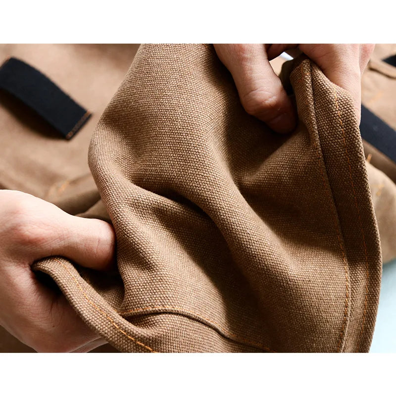 Grembiule in tela di denim con spallacci incrociati regolabili Grembiule da lavoro Autunno 2025 Logo personalizzato Tasche resistenti per attrezzi