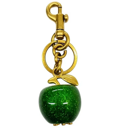 Llavero de cereza roja con charm para bolso y mosquetón dorado en forma de hoja