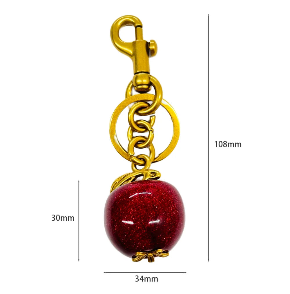 Llavero de cereza roja con charm para bolso y mosquetón dorado en forma de hoja