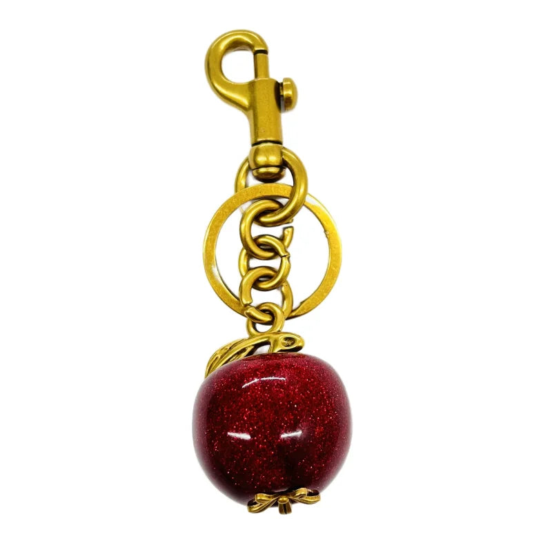 Llavero de cereza roja con charm para bolso y mosquetón dorado en forma de hoja