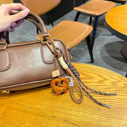 Vävda rep rosettnyckelring med söta bakverksberlocker